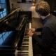 Chord inversions on the piano practised by a pianist at a grand piano