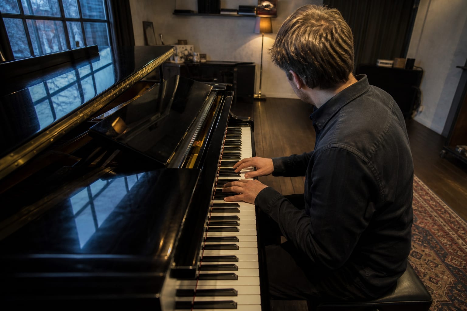 Chord inversions on the piano practised by a pianist at a grand piano