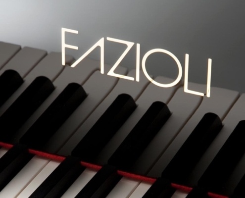 Detail of the keyboard and Fazioli logo on a F308 grand piano